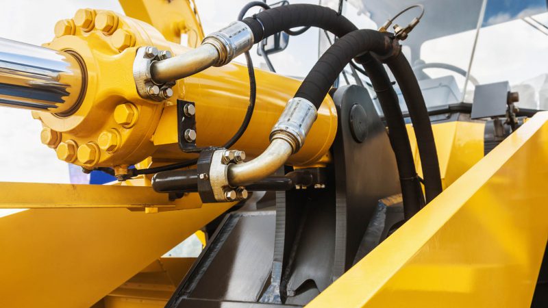 hydraulics tractor yellow. focus on the hydraulic pipes